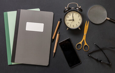 School teacher or student desk flat lay on black color background, top view