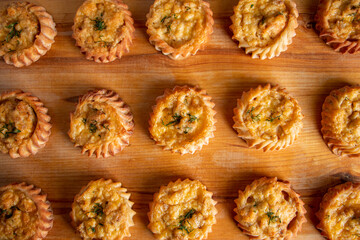 Muffins with vegetables and cheese on wooden board. Fresh homemade cakes for a healthy diet. Preparation of seasonal fall food.