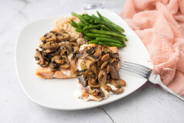 Salmon dinner with brown rice and green beans, topped with plain Greek yogurt and mushrooms.