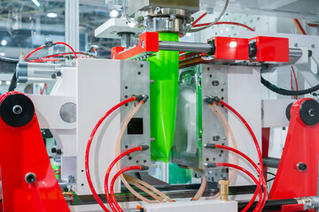 Automatic blow molding machine - manufacturing of empty green plastic jerrycans at factory,...