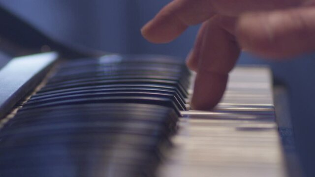 Man plays music keyboard . Musician play piano . Shot on RED EPIC Cinema Camera . Hand of pianist quikly playing with piano keys during concert 