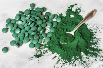Fototapeta na wymiar Spirulina Powder and Pills Healthy Dietary Supplement .Organic Green Algae - Chlorella