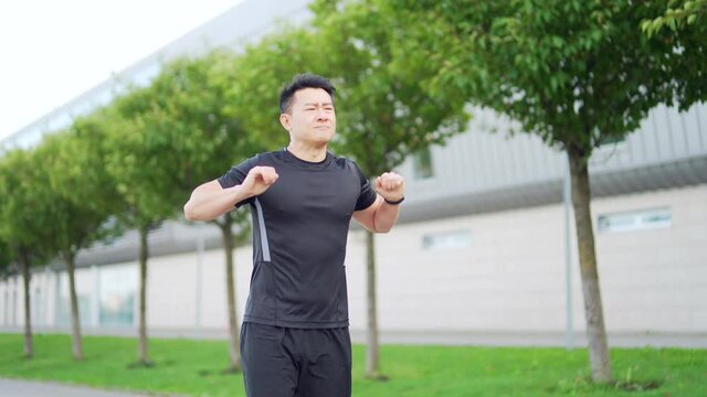Sport asian man have shoulder pain, Sport injury concept. Fitness Muscular male has neck pain and shoulders after running having an ache in his arm. athlete runner pain in joints outdoors neck