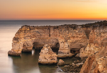 Natural arches at Marinha Beach at Twilight in Algarve Portugal
