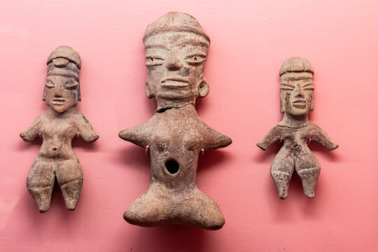 Ancient Mayan artifacts on pink surface
