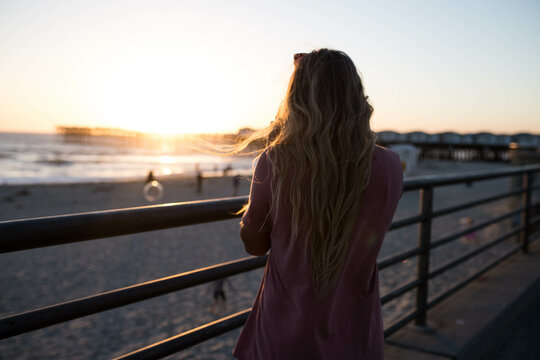 Backside of woman looking at sunset