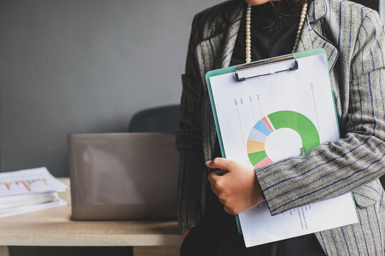 Businesswoman holding a document standing in an office
