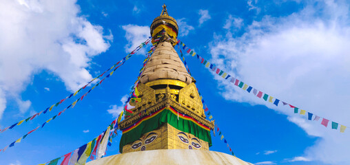 Close-up of ancient religious complex of Swayambhunath stupa with buntings in Kathmandu, Nepal