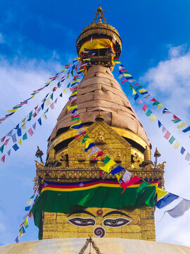 Close-up of ancient religious complex of Swayambhunath stupa with buntings in Kathmandu, Nepal
