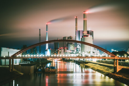 Factory near bridge during nighttime