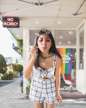 Girl blowing soap bubbles outdoor
