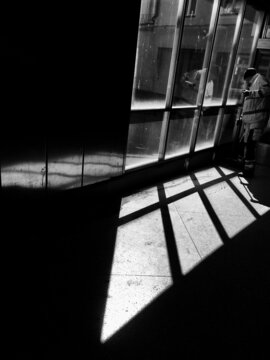 Grayscale photo of Janitor mopping the floor in the hallway