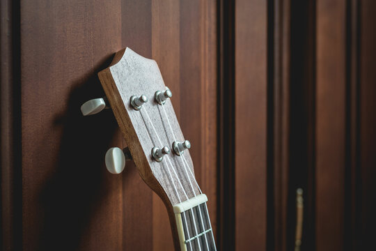 Guitar's hand beside wall