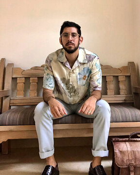 Man wearing floral shirt sitting