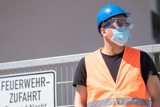 Man Wearing Safety Jacket, Goggles, Helmet And Facemask