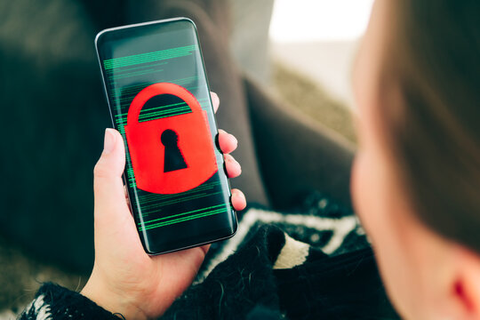 Person holding a smartphone showing padlock on screen