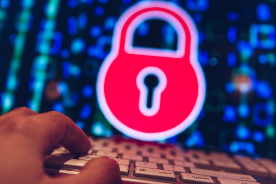 Person typing on a computer with padlock on screen