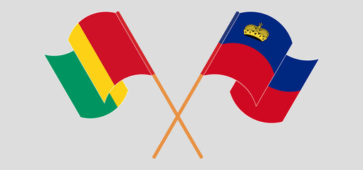 Crossed and waving flags of Guinea and Liechtenstein