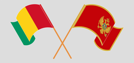 Crossed and waving flags of Guinea and Montenegro