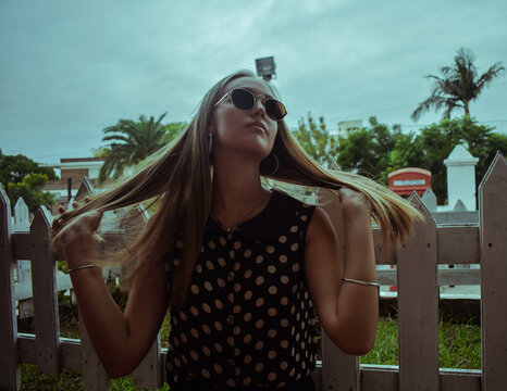 Portrait of woman with sunglasses standing outdoors