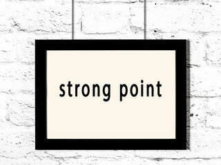 Black frame hanging on white brick wall with inscription strong point - obrazy, fototapety, plakaty