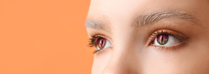 Young woman wearing creative contact lenses for Halloween party, closeup
