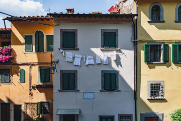 clothes hung to dry in the sun with various writings in Italian: heart, answers