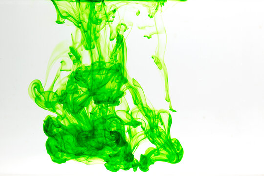 Slow motion of green liquid in clear liquid