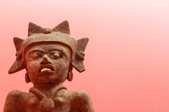 Statue of Mayan ruins in pink space