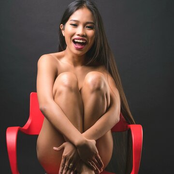 Studio portrait of smiling naked woman
