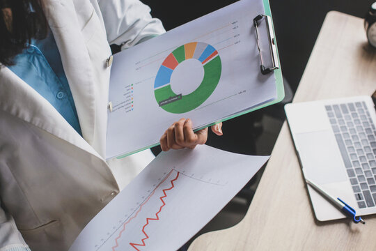 Woman holding pivot tables printed on paper