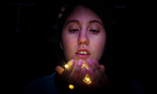Woman holding string light