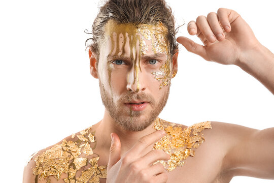 Handsome Young Man With Golden Paint On Body Against White Background