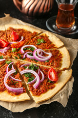 Delicious Turkish pizza on dark background