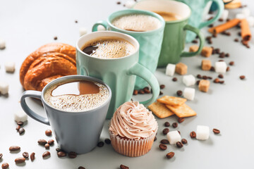 Composition with cups of tasty coffee on light background