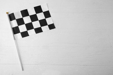 Racing flag on white wooden background