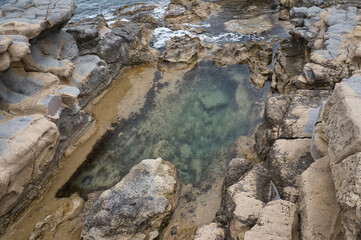 beach with rocks on the coast of the town of Morarira in the province of Alicante, Valencian community, Spain