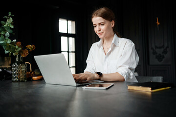 A freelancer works at home on a website and surfs in a search engine. The entrepreneur responds to...