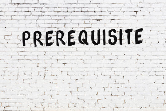 Inscription prerequisite painted on white brick wall
