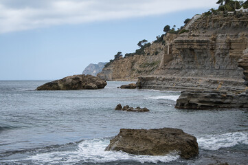 beach with rocks on the coast of the town of Morarira in the province of Alicante, Valencian...
