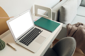 Fototapeta na wymiar Modern workplace with laptop near color wall