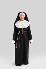 Mature nun on light background