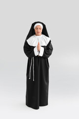 Mature nun on light background