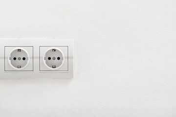 Electric socket on light wall