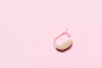 Hearing aid on color background