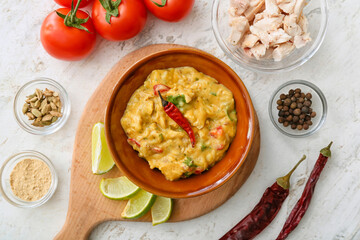 Composition with tasty chicken curry on light background
