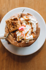 messy overflowing hot drinking chocolate whipped cream toasted marshmallow caramel sprinkles conversation heart 