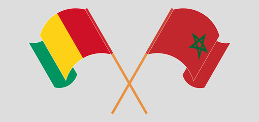 Crossed and waving flags of Guinea and Morocco