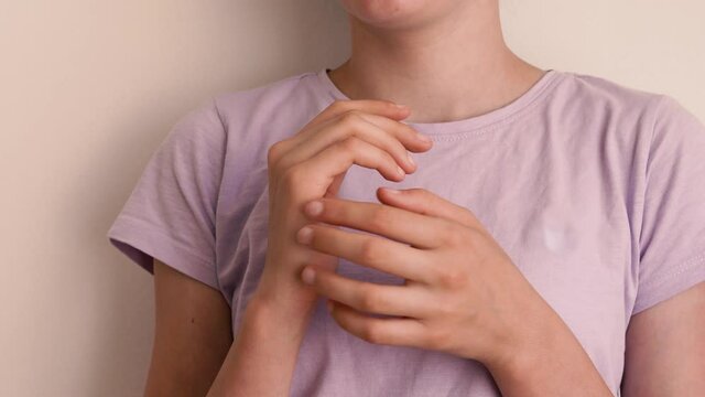Young teenage girl practicing EFT or emotional freedom technique - tapping on the karate chop point