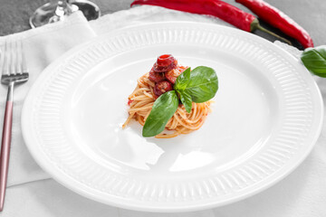 Plate with tasty Pasta Puttanesca on table